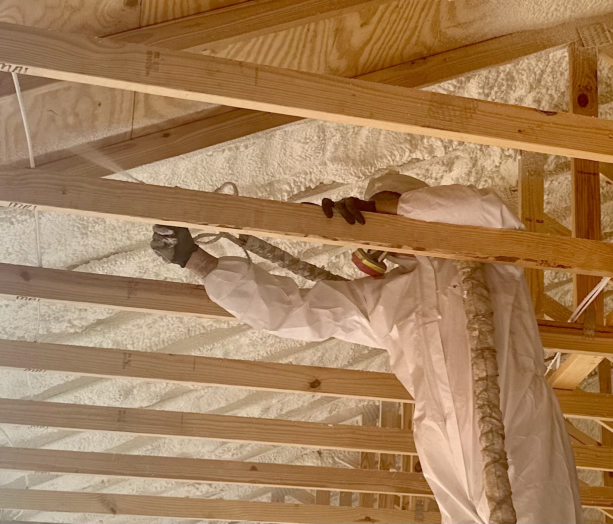 Insulflo crew installing spray foam insulation.