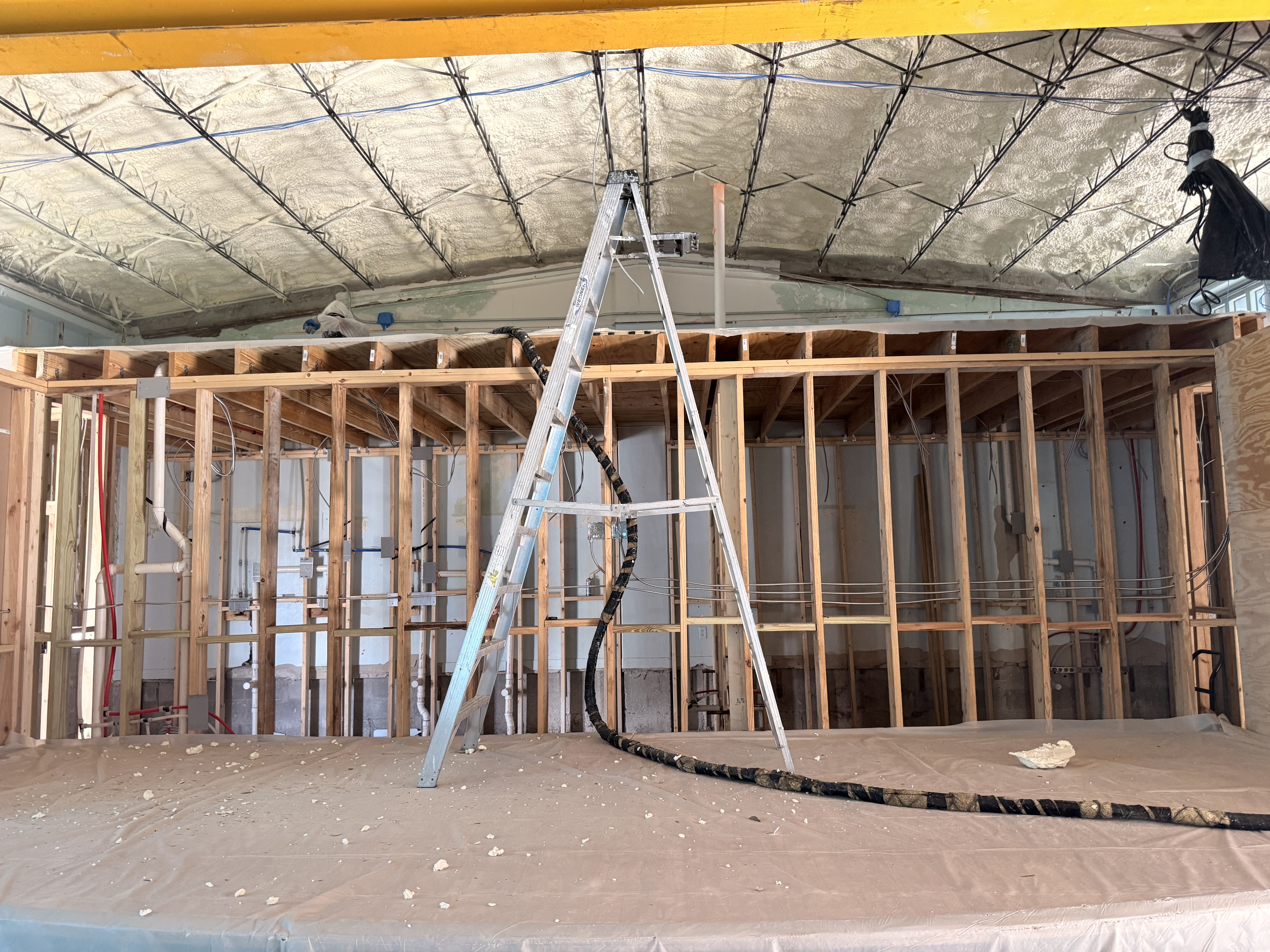 Spray foam insulation applied along ceiling joists